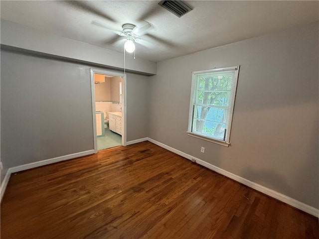 6 Elizabeth Ave, Chickasaw, AL 36611 - unfurnished bedroom with wood finished floors, connected bathroom, and ceiling fan