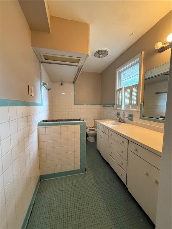 6 Elizabeth Ave, Chickasaw, AL 36611 - full bath with tile walls, vanity, tiled shower, wainscoting, and tile patterned floors