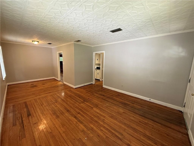6 Elizabeth Ave, Chickasaw, AL 36611 - spare room featuring hardwood / wood-style flooring, an ornate ceiling, and ornamental molding