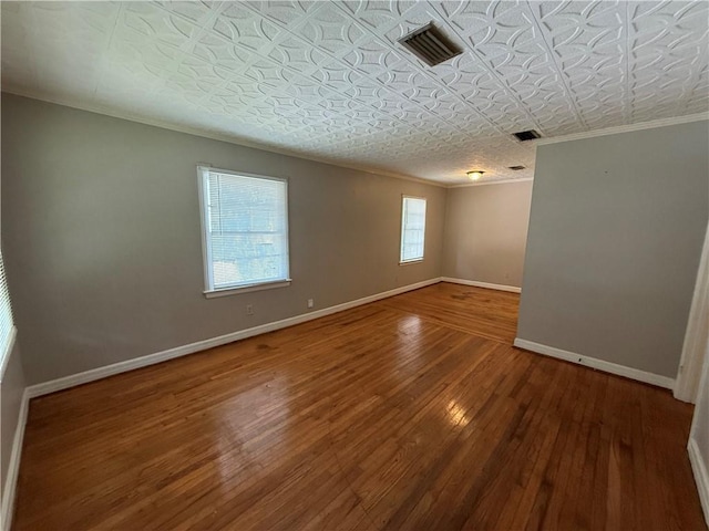 6 Elizabeth Ave, Chickasaw, AL 36611 - spare room with hardwood / wood-style floors, ornamental molding, and an ornate ceiling