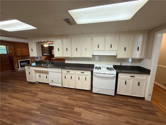 6 Elizabeth Ave, Chickasaw, AL 36611 - kitchen with white appliances, dark countertops, under cabinet range hood, and dark wood finished floors