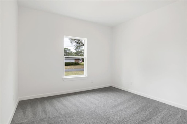 empty room with baseboards and carpet floors