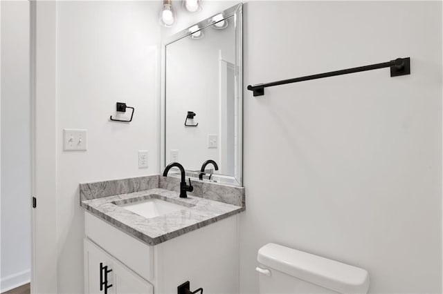 bathroom with toilet and vanity