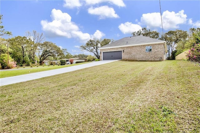 view of home's exterior featuring an attached garage, a lawn, and driveway