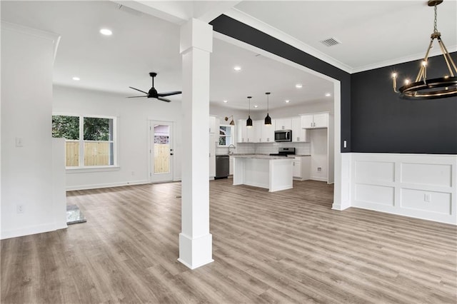 unfurnished living room featuring recessed lighting, visible vents, ceiling fan with notable chandelier, and light wood finished floors