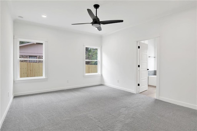 spare room featuring carpet flooring, a ceiling fan, and baseboards