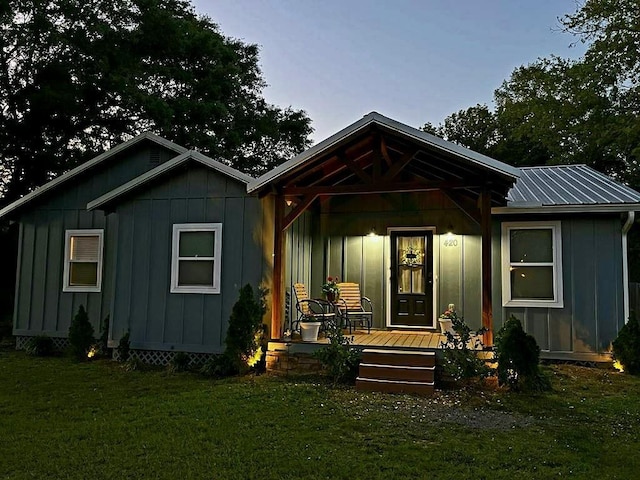 420 3rd Ave, Saraland, AL 36571 - view of front of property featuring board and batten siding, covered porch, a front yard, and metal roof