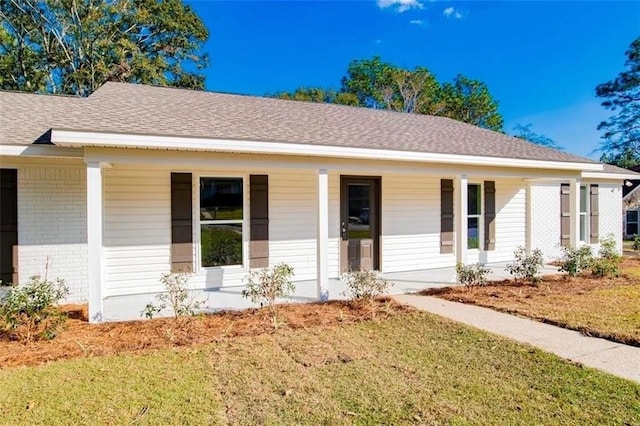 single story home with covered porch and a front lawn