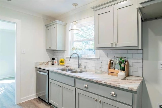 kitchen featuring backsplash, sink, gray cabinets, stainless steel dishwasher, and light stone counters