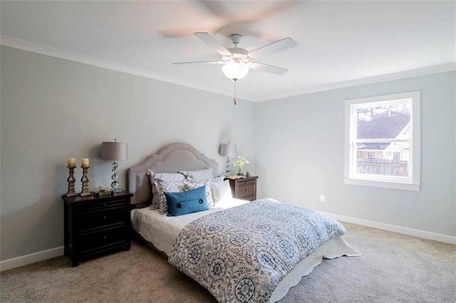 carpeted bedroom with ceiling fan and crown molding