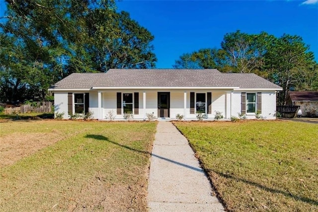 ranch-style house with covered porch and a front yard