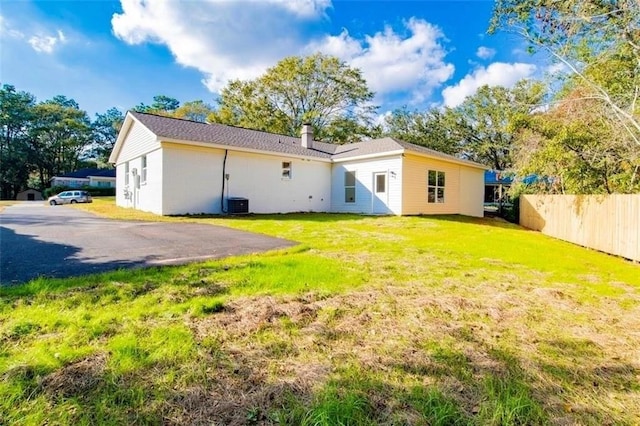 back of property with a yard and cooling unit