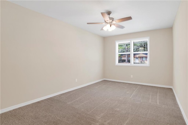 empty room featuring a ceiling fan, carpet, and baseboards