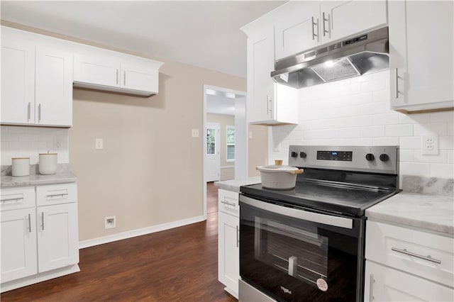 kitchen featuring under cabinet range hood, dark wood-type flooring, white cabinetry, light stone countertops, and stainless steel range with electric stovetop