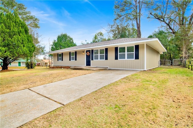 single story home featuring fence and a front lawn