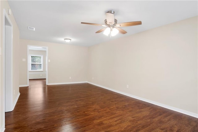 unfurnished room with ceiling fan, baseboards, and dark wood-style flooring