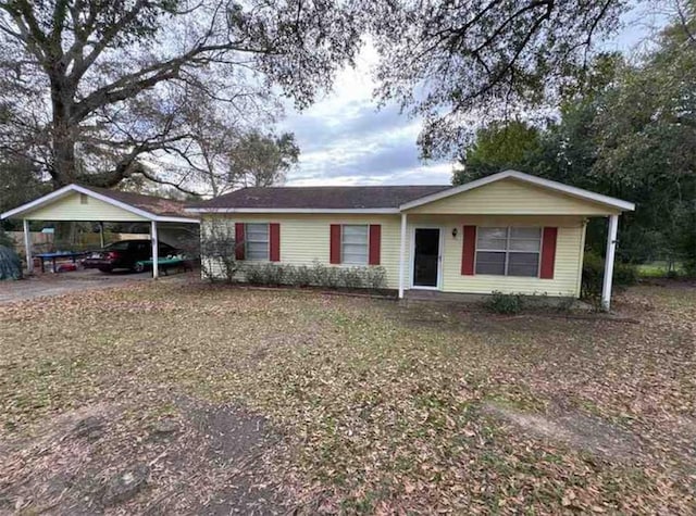 ranch-style house featuring a carport