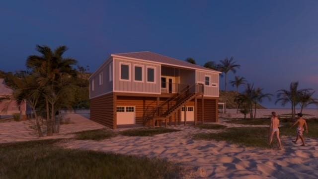 view of front of house with a garage, board and batten siding, and stairs