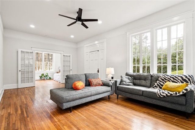 living room with ceiling fan, french doors, and hardwood / wood-style floors