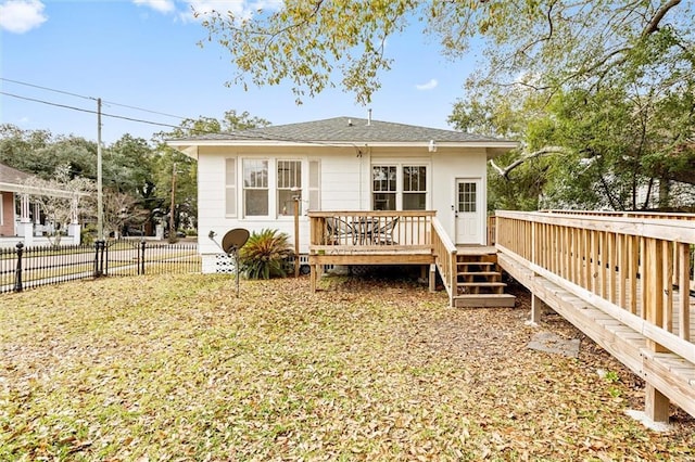 rear view of property featuring a deck