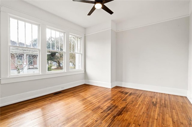 empty room with ceiling fan and wood-type flooring