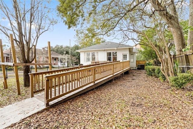 rear view of house featuring a wooden deck and central AC