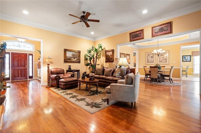 living room with recessed lighting, ornamental molding, baseboards, and wood-type flooring