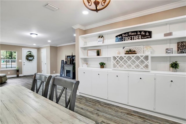 dining room featuring ornamental molding and hardwood / wood-style floors