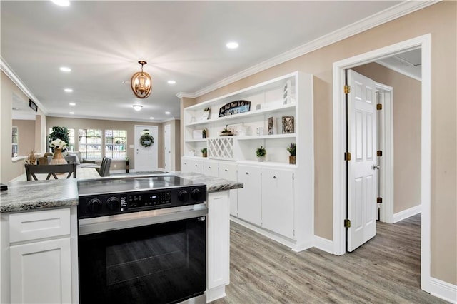 kitchen featuring decorative light fixtures, ornamental molding, electric stove, light stone countertops, and white cabinets