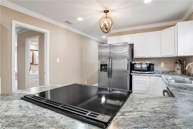 kitchen featuring stainless steel appliances, sink, hanging light fixtures, and white cabinets