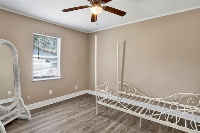 unfurnished bedroom with crown molding, wood-type flooring, and ceiling fan