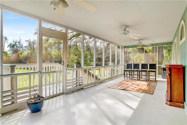 sunroom featuring ceiling fan