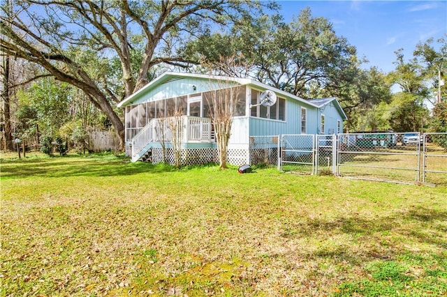 view of front of house featuring a sunroom and a front yard