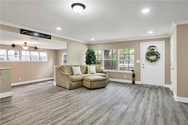 living room with wood-type flooring, ornamental molding, and ceiling fan