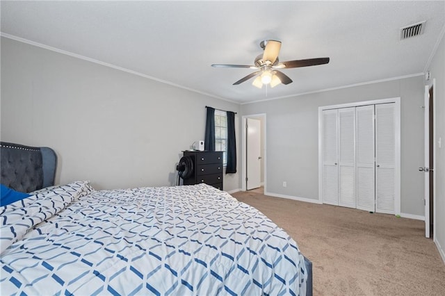 bedroom with carpet flooring, a closet, ceiling fan, and crown molding