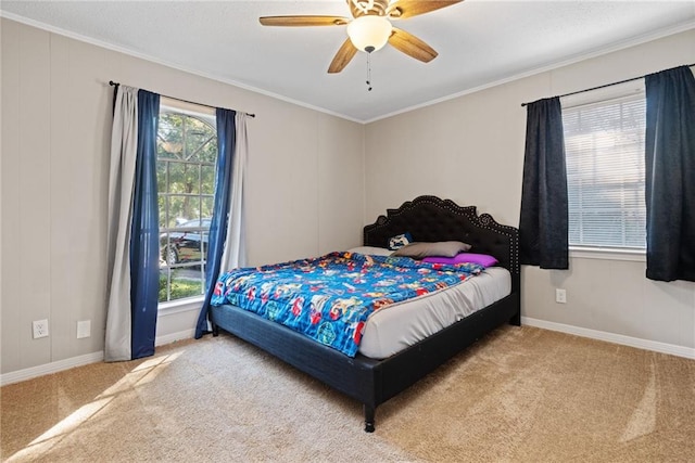 carpeted bedroom featuring ceiling fan and ornamental molding