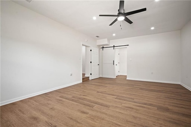 3001 Demetropolis Rd, Mobile, AL 36693 - interior space with recessed lighting, a barn door, baseboards, and wood finished floors