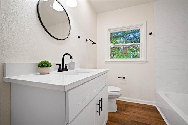 3001 Demetropolis Rd, Mobile, AL 36693 - bathroom with toilet, baseboards, wood finished floors, and vanity