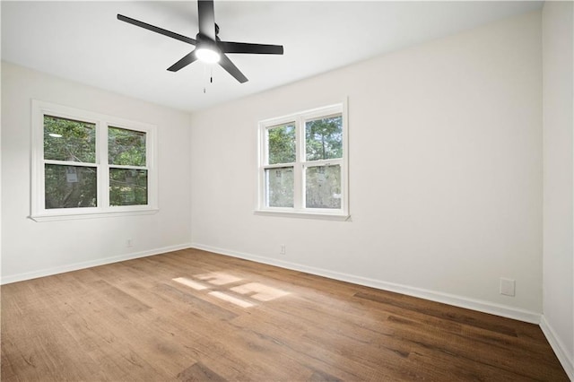 3001 Demetropolis Rd, Mobile, AL 36693 - spare room featuring baseboards, a healthy amount of sunlight, and wood finished floors
