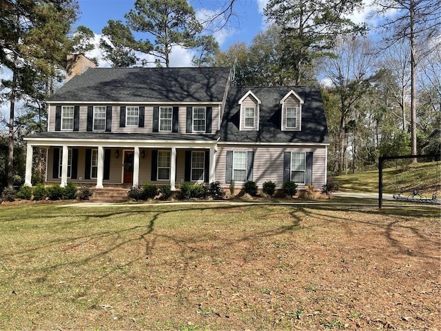 colonial home with a porch and a front lawn