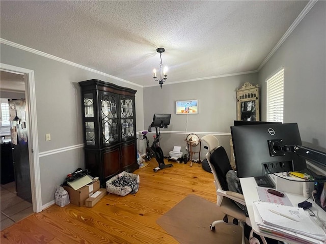 office with a wealth of natural light, a textured ceiling, crown molding, and wood finished floors