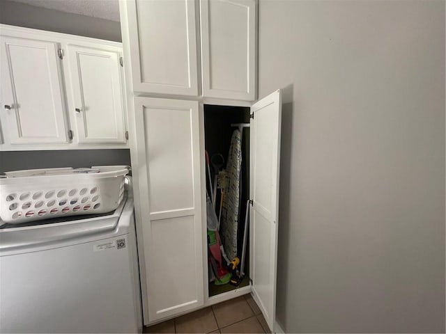 washroom with cabinet space and tile patterned flooring