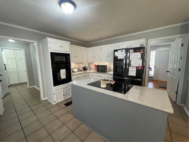 kitchen featuring black appliances, white cabinets, crown molding, and tile patterned floors