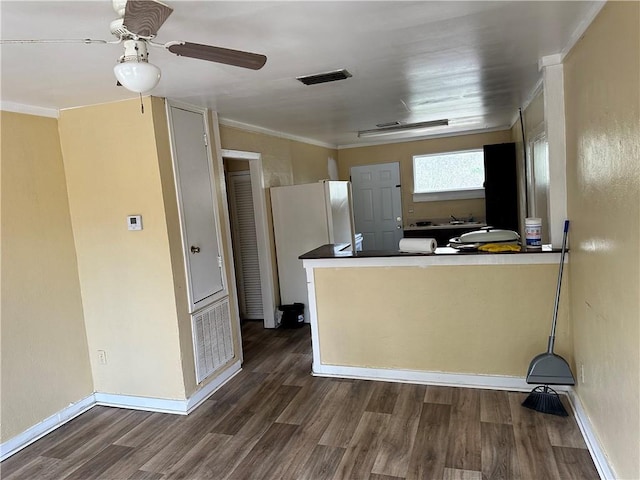 kitchen featuring ceiling fan, dark hardwood / wood-style flooring, kitchen peninsula, and crown molding