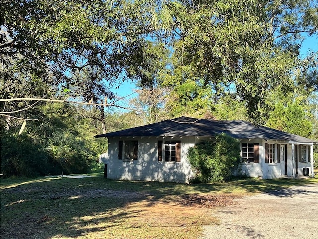 view of property exterior featuring a lawn