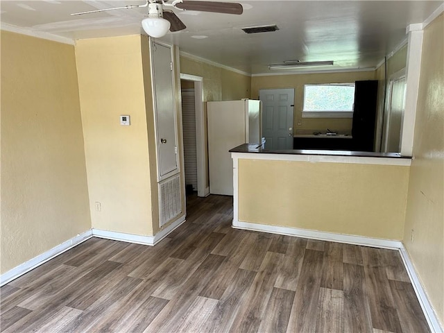 kitchen featuring hardwood / wood-style floors, ceiling fan, white refrigerator, and ornamental molding