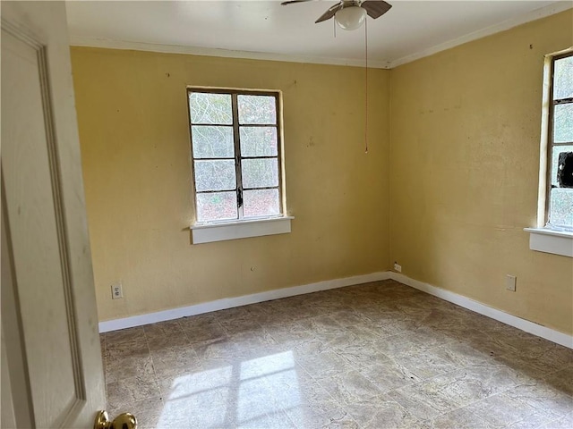 unfurnished room with ceiling fan and crown molding