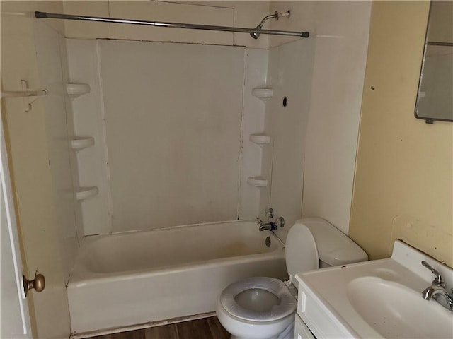 full bathroom featuring hardwood / wood-style floors, vanity, toilet, and tub / shower combination