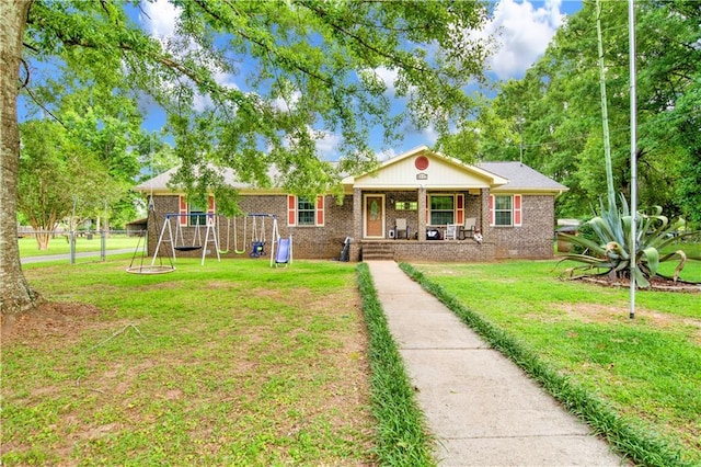8717 Louis Poiroux Rd N, Theodore, AL 36582 - view of front of house with a playground, brick siding, and a porch
