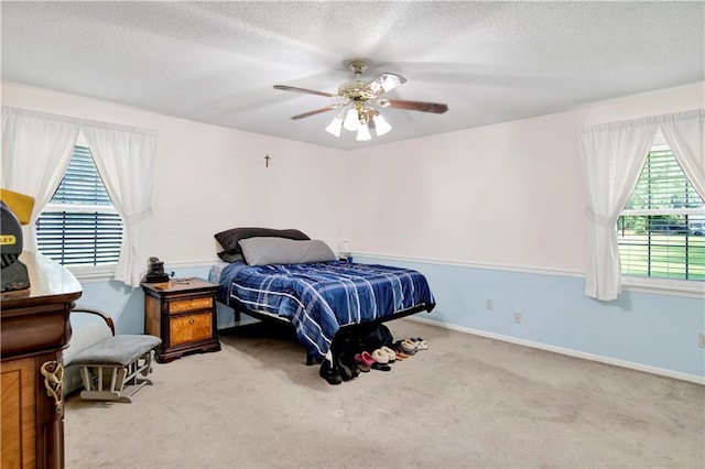 8717 Louis Poiroux Rd N, Theodore, AL 36582 - bedroom featuring carpet flooring, a textured ceiling, a ceiling fan, and baseboards